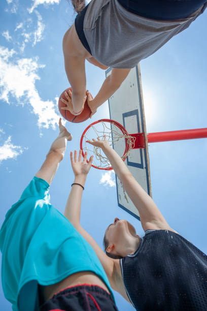 istock Friends playing basketball game on a sunny day 1327699145