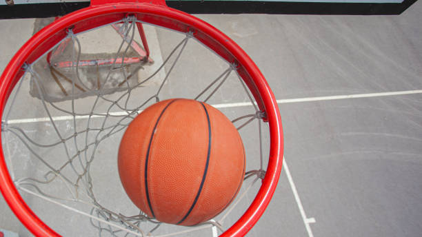 istock A basketball swishes through the net 1327699394