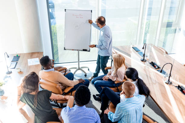 Confident business trainer coach give flip chart presentation