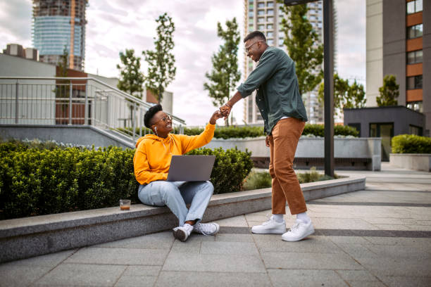 istock Young colleagues greeting in a front of office 1327703338