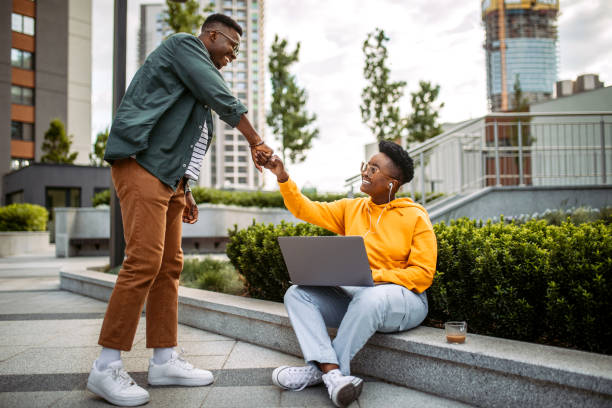 Young colleagues greeting in a front of office