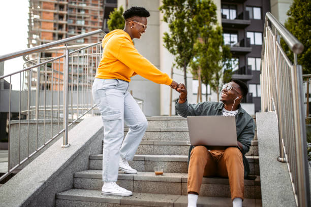 istock Young colleagues greeting in a front of office 1327703367
