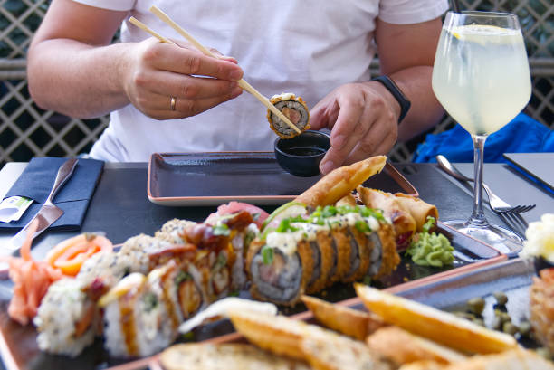 istock eating sushi with chopsticks at sushi restaurant 1327703443