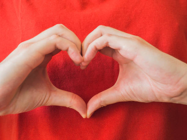 istock Unrecognizable person with heart shaped hands 1327703650