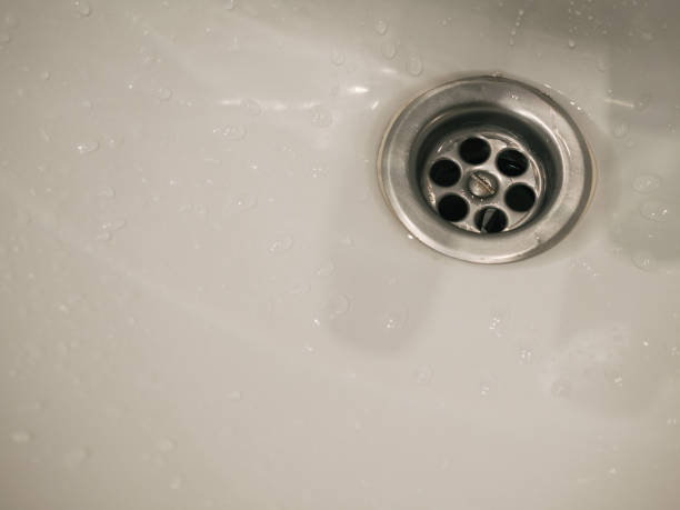 istock Stainless steel bathroom drain close up and with white copy space 1327703663
