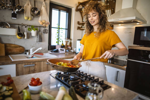 istock Woman cooking vegetables in the kitchen 1327704268
