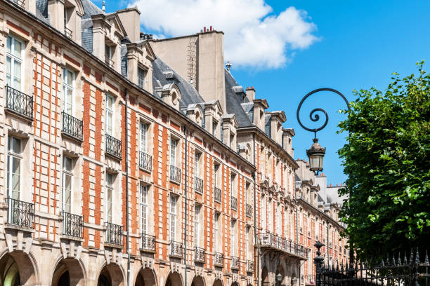 Paris France,April 23, 2018: Tourists seating in the park at Place des Vosges Paris