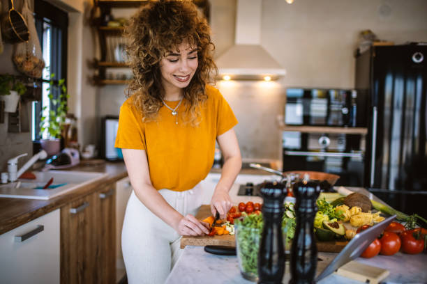 istock Young women making healthy meal in the kitchen 1327704625