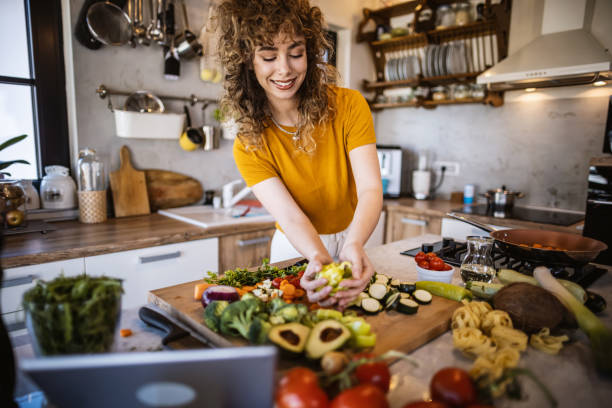 istock Young women making healthy meal in the kitchen 1327704767