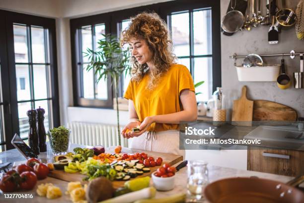 Young Women Making Healthy Meal In The Kitchen Stock Photo - Download Image Now - 20-29 Years, Adult, Adults Only