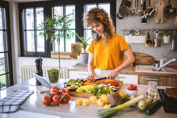 istock Young women making healthy meal in the kitchen 1327704871
