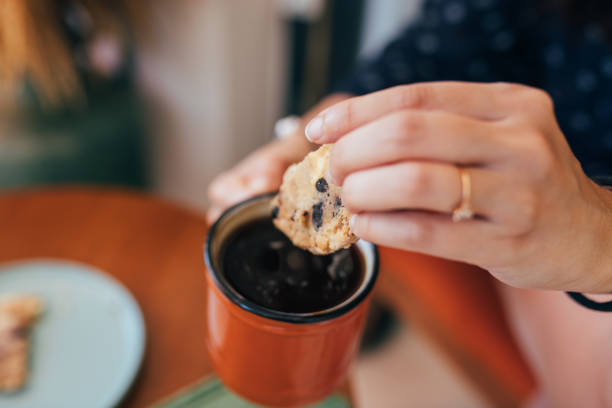 istock Woman dunking cookies in coffee 1327705414