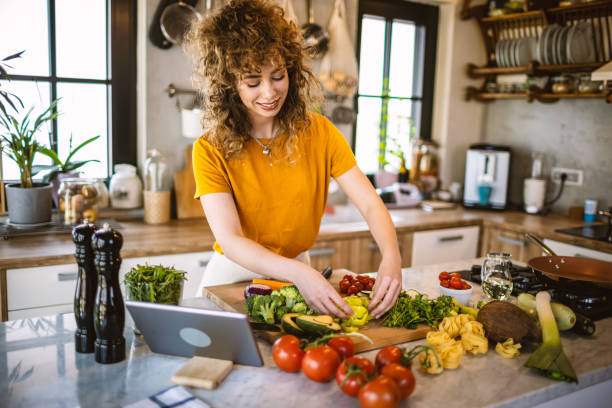 istock Young women making healthy meal in the kitchen 1327705421