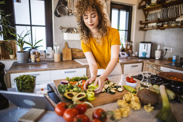 istock Young women making healthy meal in the kitchen 1327705558