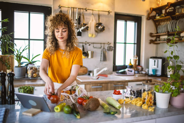 istock Young women making healthy meal in the kitchen 1327705588