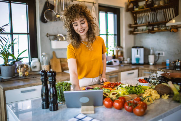 istock Young women making healthy meal in the kitchen 1327705765