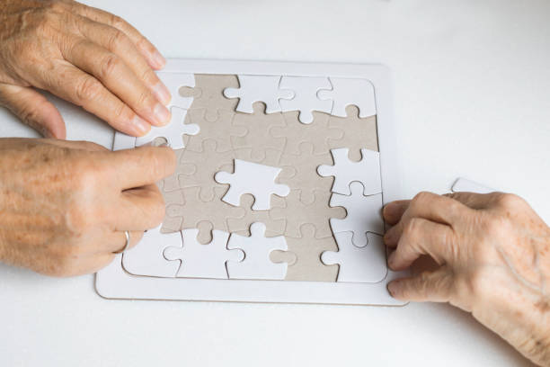 istock Senior Couple is Playing Puzzle. 1327705815