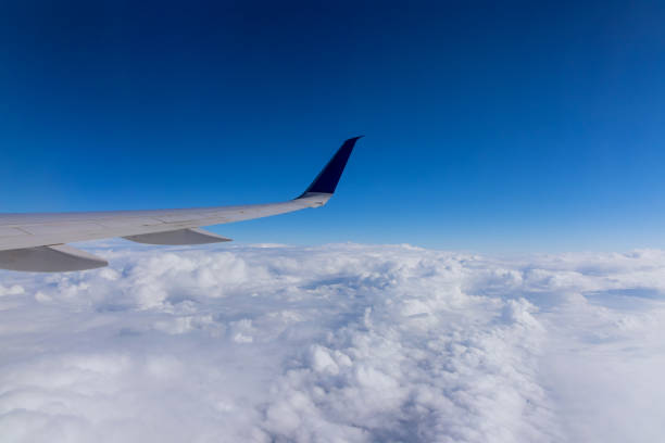 Wing aircraft in altitude during airplane flying above the clouds