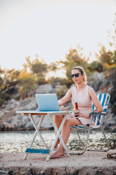 istock Freelance Woman Working With Laptop on the Beach 1327710279