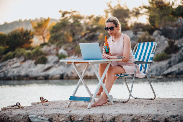 istock Freelance Woman Working With Laptop on the Beach 1327710862