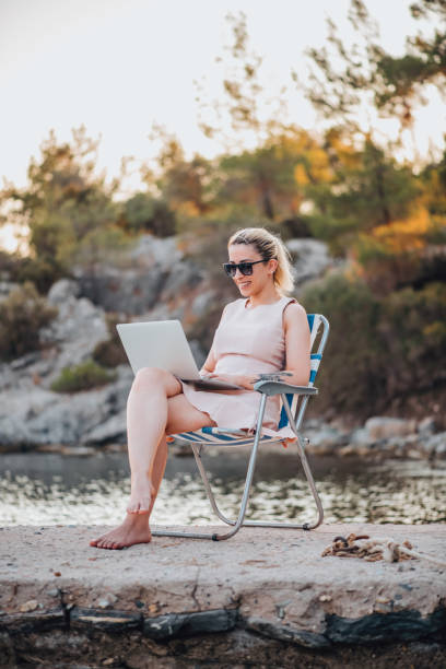 istock Freelance Woman Working With Laptop on the Beach 1327711038