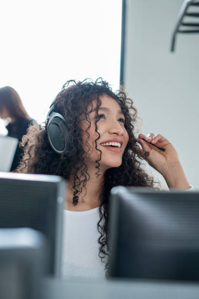 istock curly haired latin woman working in front of her computer inside her office 1327712640