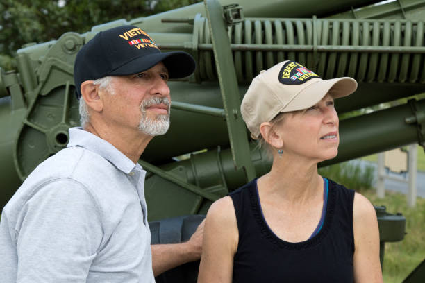 istock Military veterans looking skyward in front of artillery 1327713581