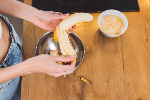 istock Woman hands peeling banana 1327713672