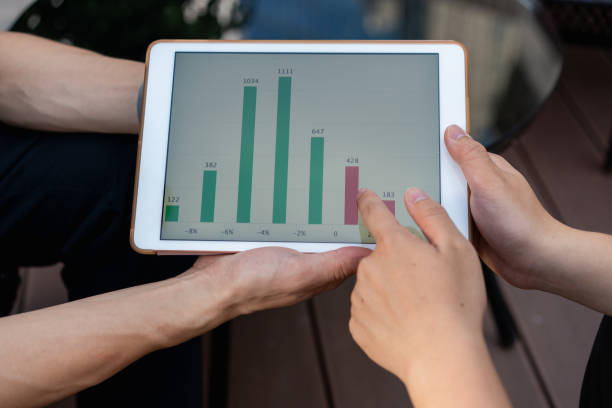 istock Two Asian men are using a tablet to view income statements 1327715345
