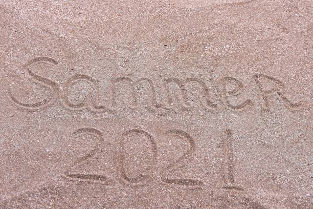 istock summer 2021. an inscription on the sand. beach 1327715593