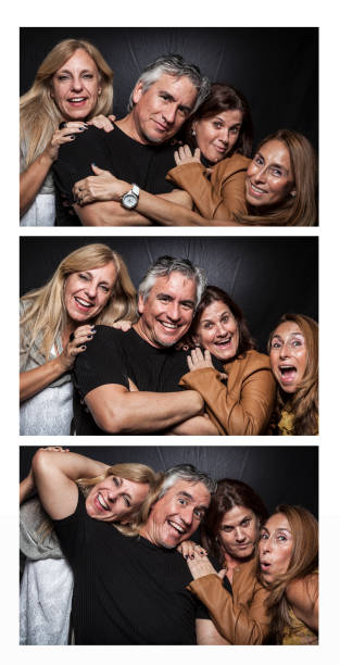 istock Man and three women in photo booth having fun 1327720024