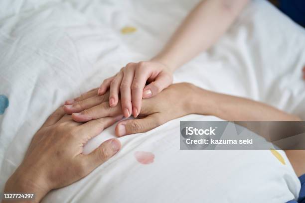 At The Hands Of An Elderly Asian Who Is Seen At The End Stock Photo - Download Image Now