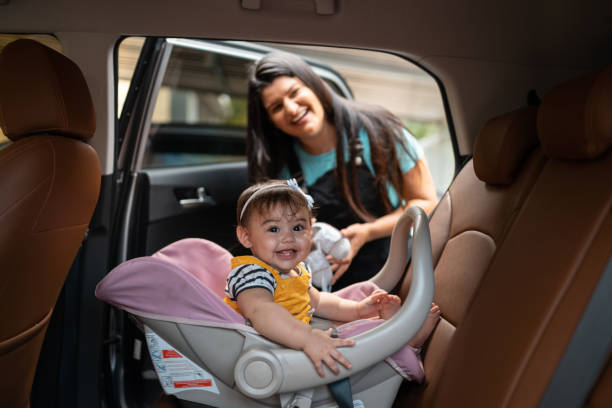istock Mother daughter baby seat looking at camera 1327725292