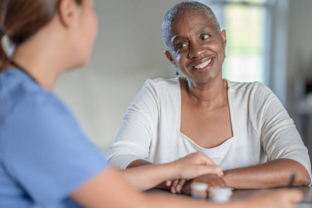 istock Cancer patient smiling while discussing with nurse 1327728503