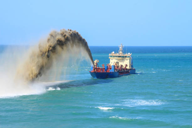 istock Sand pumping dredge boat in the pacific ocean pumping out sand. 1327730008