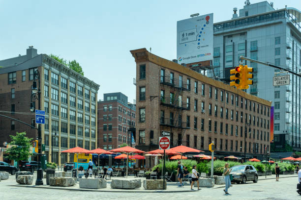 Landscape view of a public square in the trendy Meatpacking District at the intersection of West 14th Street, Hudson Street and 9th Avenue. New York, NY - USA - July 6, 2021: Landscape view of a public square in the trendy Meatpacking District at the intersection of West 14th Street, Hudson Street and 9th Avenue. logan west stock pictures, royalty-free photos & images