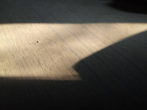 istock Wooden table exposed to sunlight in certain areas 1327735062