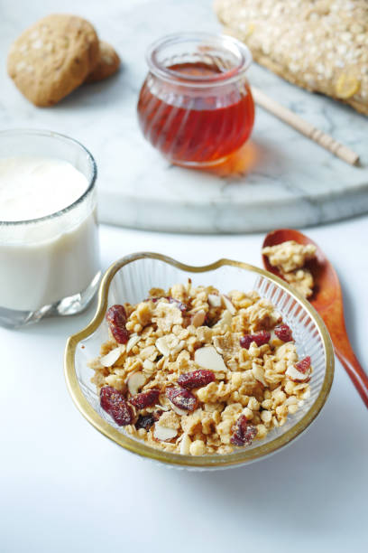 istock cereal breakfast in bowl, honey and milk on white background 1327735948