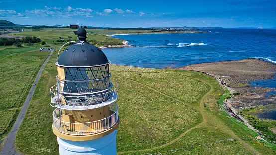 Drone point of view of top of deactivated lighthouse on Scottish coast