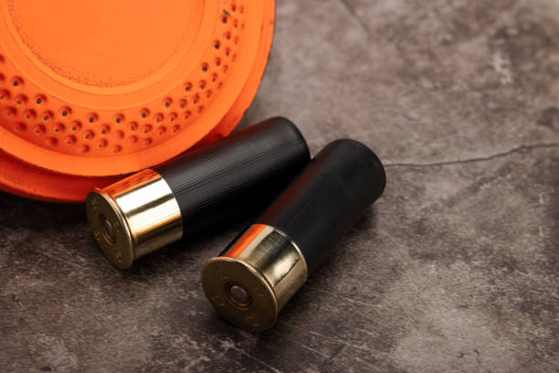 istock Clay disc flying targets and shotgun shells on texture background ,Clay Pigeon target game 1327744142