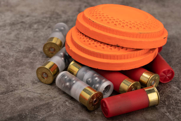 istock Clay disc flying targets and shotgun shells on texture background ,Clay Pigeon target game 1327744156