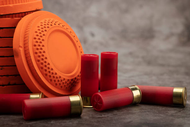 istock Clay disc flying targets and shotgun shells on texture background ,Clay Pigeon target game 1327744164