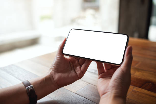 istock a woman holding mobile phone with blank white desktop screen 1327744779