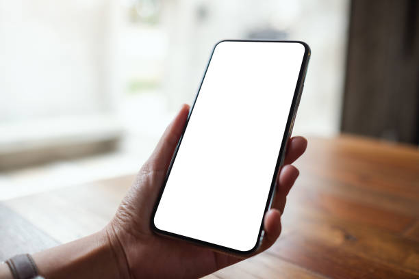istock a woman holding mobile phone with blank white desktop screen 1327744844