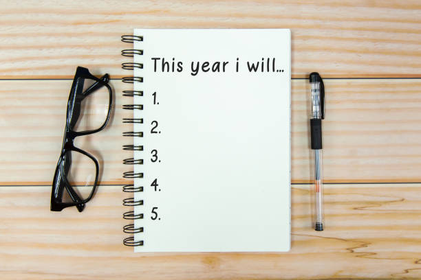 open notebook with text "this year i will" and eyeglass on wooden background - new year's resolutions concept - condition optimal text healthy lifestyle imagens e fotografias de stock