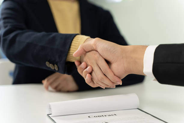 istock Close-up business people shaking hands in office 1327745595