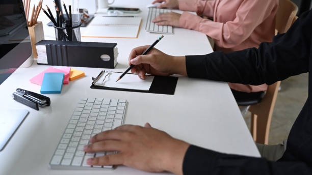 istock Cropped shot office worker working together in modern office. 1327747447