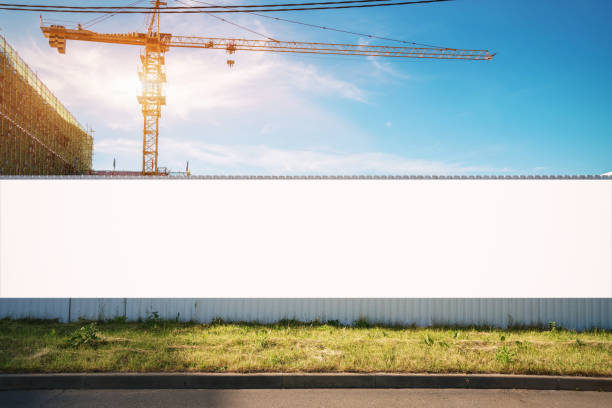 White blank hoarding poster with mockup space on construction site White blank hoarding poster with mockup space on construction site under blue sky greed stock pictures, royalty-free photos & images