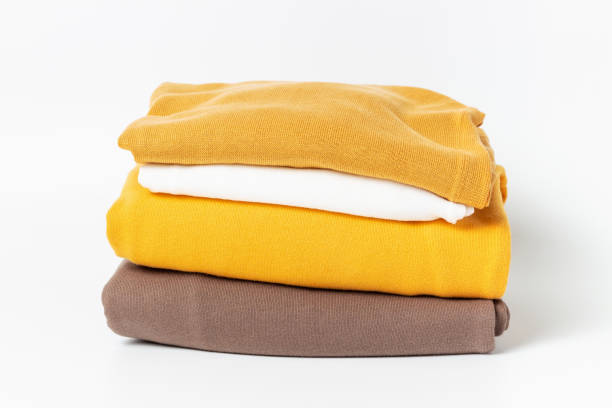 istock A stack of clothes isolated on white background close-up. 1327749535