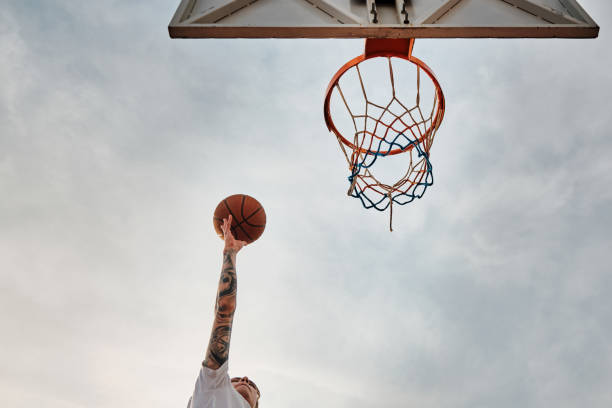 istock Hand throws basketball to the hoop 1327749576
